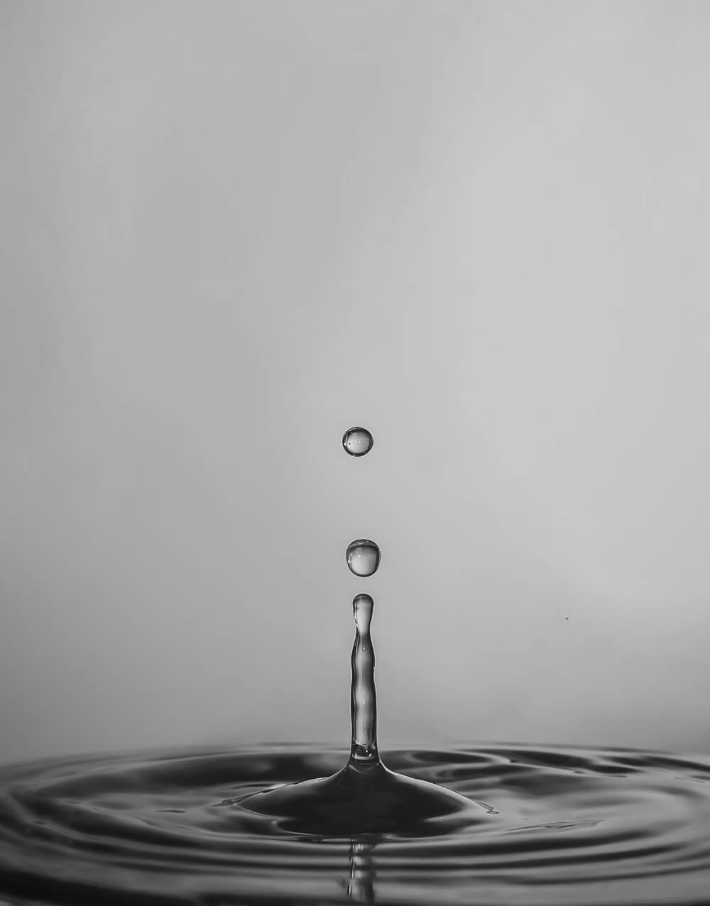 Water drop dropping down into the water