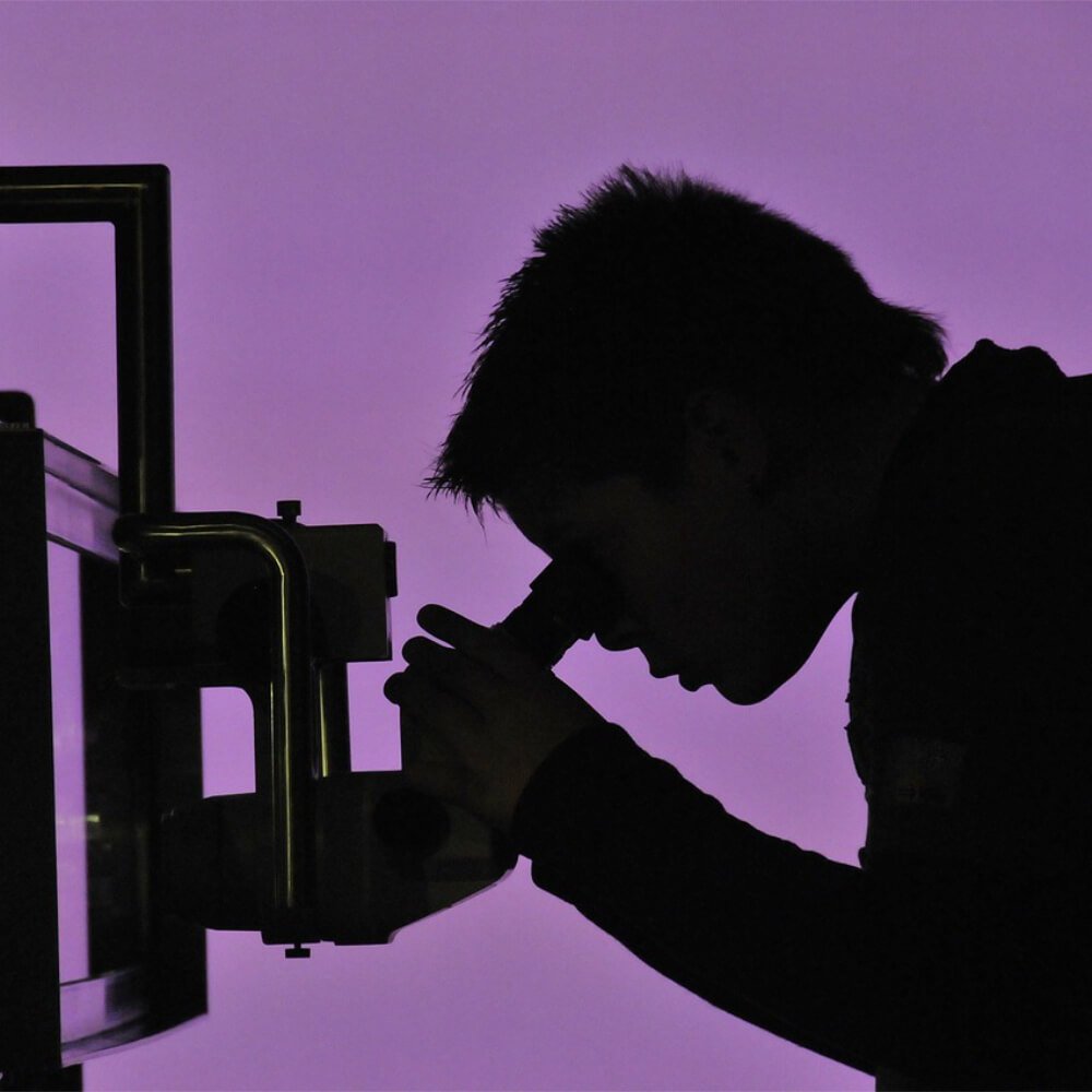 Man looking through a microscope
